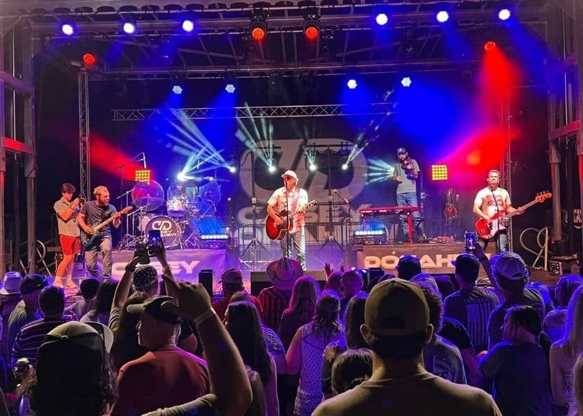 a live band playing on stage at chingawassa days festival in 2024
